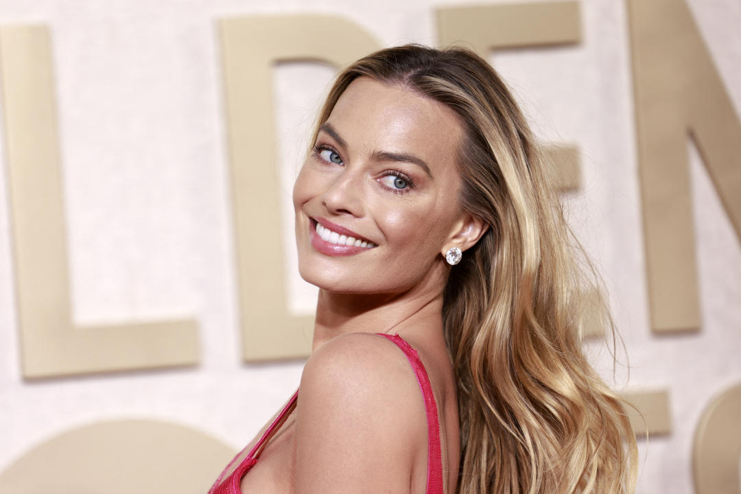 Margot Robbie poses on the red carpet after arriving at the Golden Globes in Beverly Hills, Calif., on Sunday. (Michael Tran/AFP via Getty Images