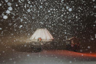 In this photo provided by the Mammoth Mountain Ski Area, fresh snow surrounds the Mammoth Mountain ski lift in Mammoth Lakes, Calif., on Monday, Dec. 13, 2021. Forecasters say the state's highest peaks could get as much as 8 feet of snow while lower elevations across California are in for a serious drenching of rain. The storm is expected to last days before moving out, but another storm is on the way. Forecasters warned people in mountainous areas to prepare for days of snowfall and possible road closures. (Peter Morning/Mammoth Mountain Ski Area via AP)