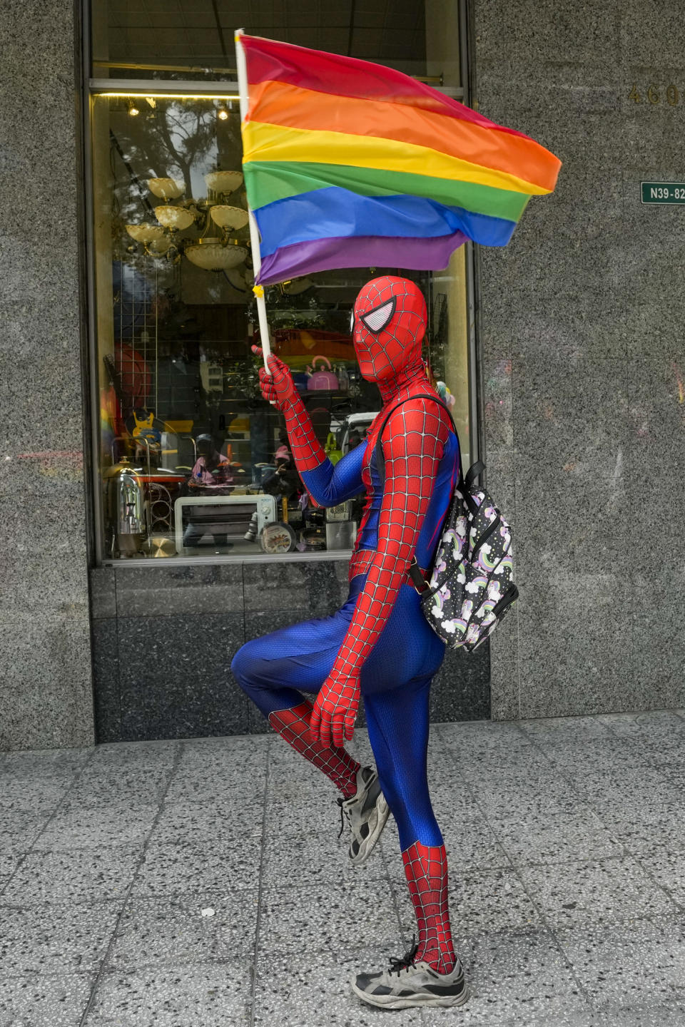 A participant in a Spiderman costume and waving a rainbow banner takes part in the annual Gay Pride Parade in Quito, Ecuador, Saturday, June 22, 2024. (AP Photo/Dolores Ochoa)