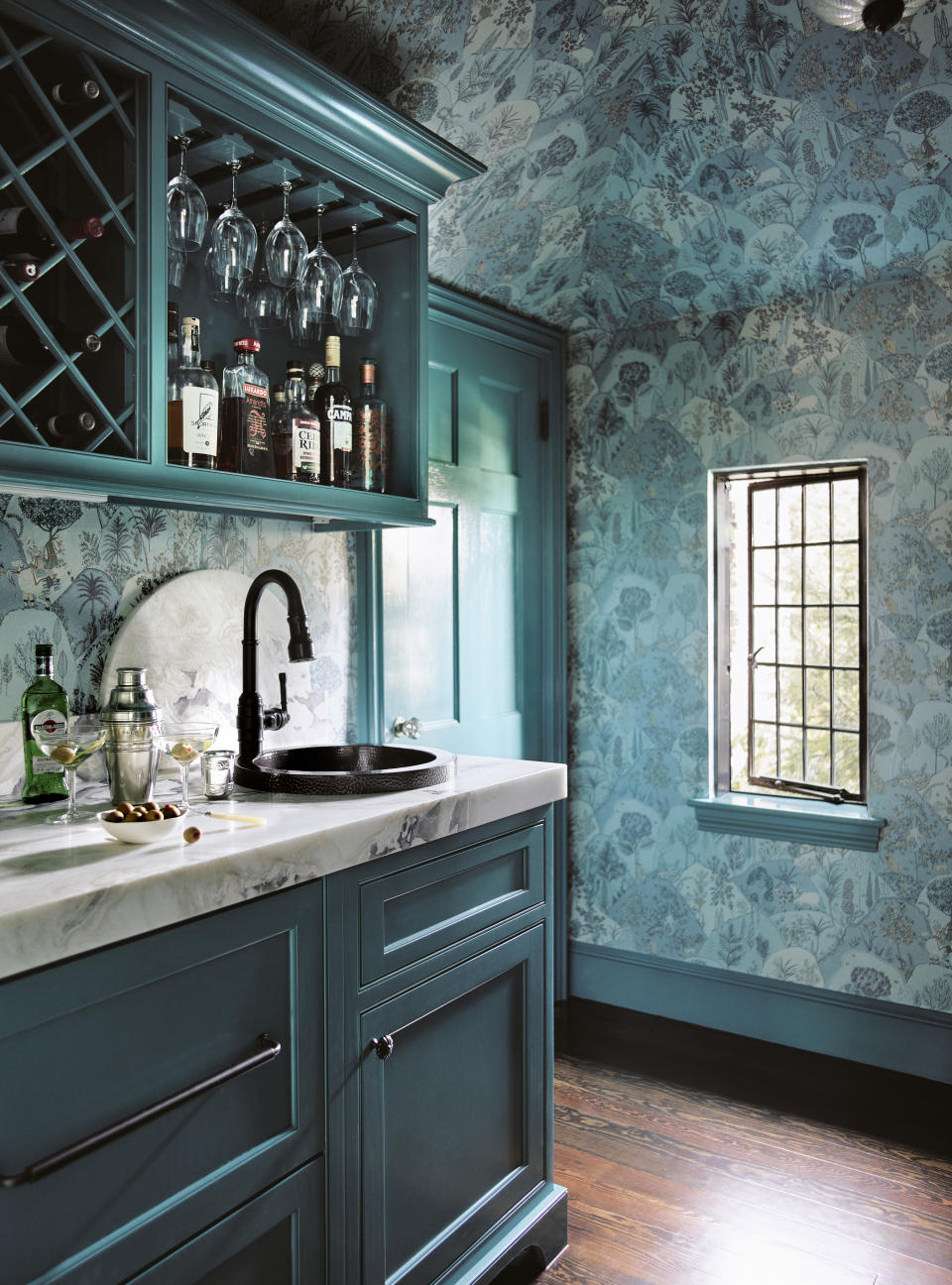 A bar with a sink and marble countertop