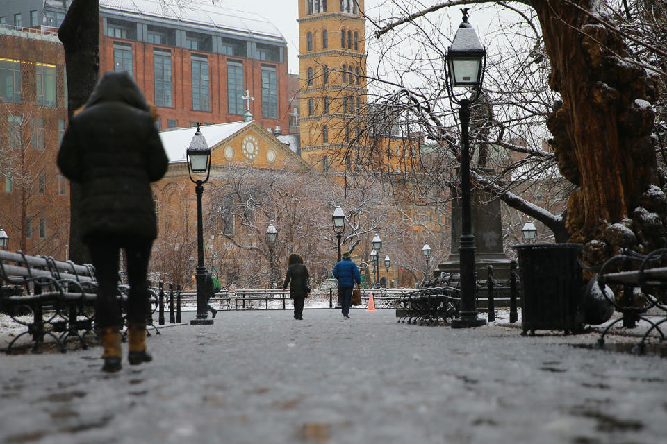 <p>A woman walks through Washington Square Park in New York City as snow turns to rain as the second storm in week hits the northeast on March 7, 2018. (Photo: Gordon Donovan/Yahoo News) </p>