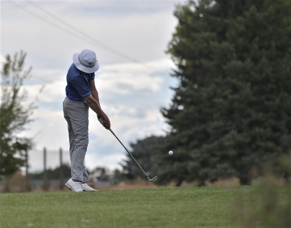 Poudre golfer Max Riley makes contact with his tee shot on the par-3 14th hole during the Colorado 5A boys golf state championships on Tuesday, Oct. 3, 2023 at Collindale Golf Course in Fort Collins, Colo.