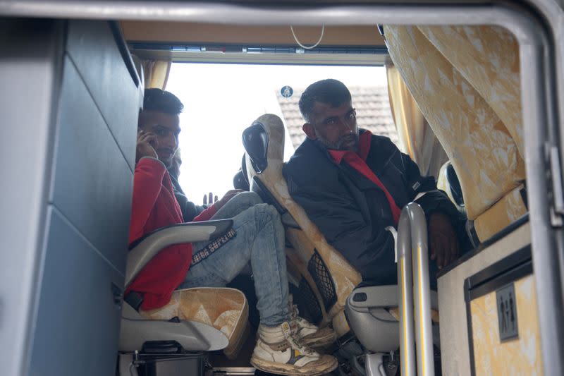 Migrants are seen in a bus near migrant camp in Vucjak