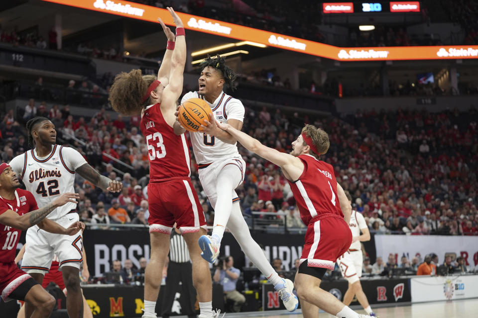 Illinois guard Terrence Shannon Jr., center, goes up for a shot as Nebraska forward Josiah Allick (53) and guard Sam Hoiberg, right, defend during the first half of an NCAA college basketball game in the semifinal round of the Big Ten Conference tournament, Saturday, March 16, 2024, in Minneapolis. (AP Photo/Abbie Parr)