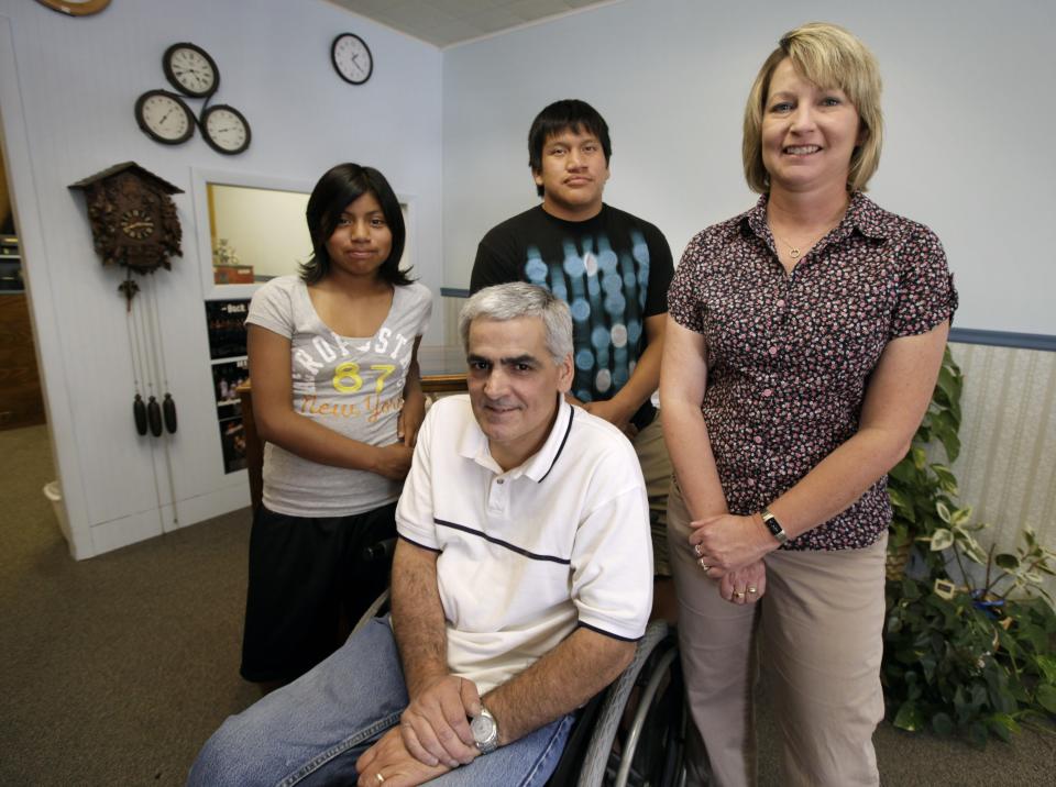 This Thursday, June 14, 2012 photo shows Mike Lamm with his wife, Tracey, daughter Raeann and son Ethan in the showroom of his jewelry shop in Mediapolis, Iowa. Even working 65 to 75 hours a week, Mike is bringing in less than he did last year. They have little saved for their children's college. At best, they hope to help pay off their student loans. But they hold on to hopes, if not for themselves, then at least for their kids. When the government reported that the Great Recession claimed nearly 40 percent of Americans' wealth, the figure alarmed economists. But for families across the country, the numbers merely confirm that they are not alone. (AP Photo/Charlie Neibergall)