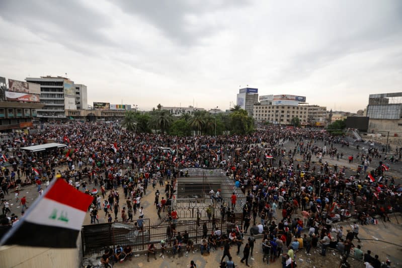 Demonstrators are seen during a protest over corruption, lack of jobs, and poor services, in Baghdad