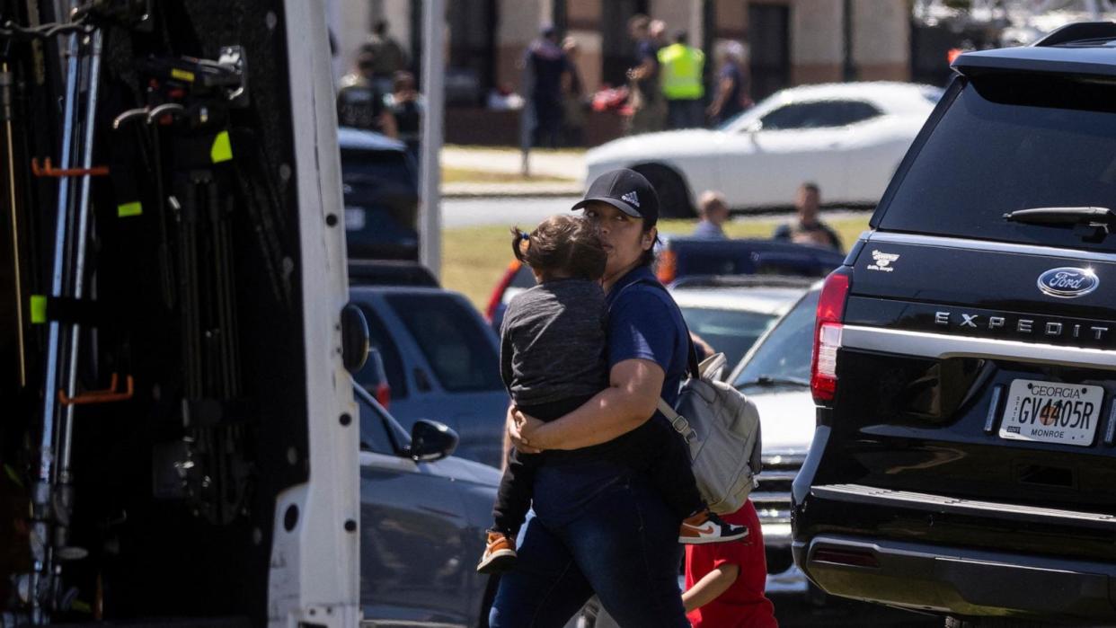 PHOTO: Parents arrive to pick up their children after a shooting at Apalachee High School in Winder, Georgia, on September 4, 2024. (Christian Monterrosa/AFP via Getty Images)