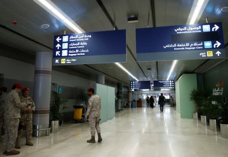 Saudi security officers are seen at Saudi Arabia's Abha airport, after it was attacked by Yemen's Houthi group in Abha