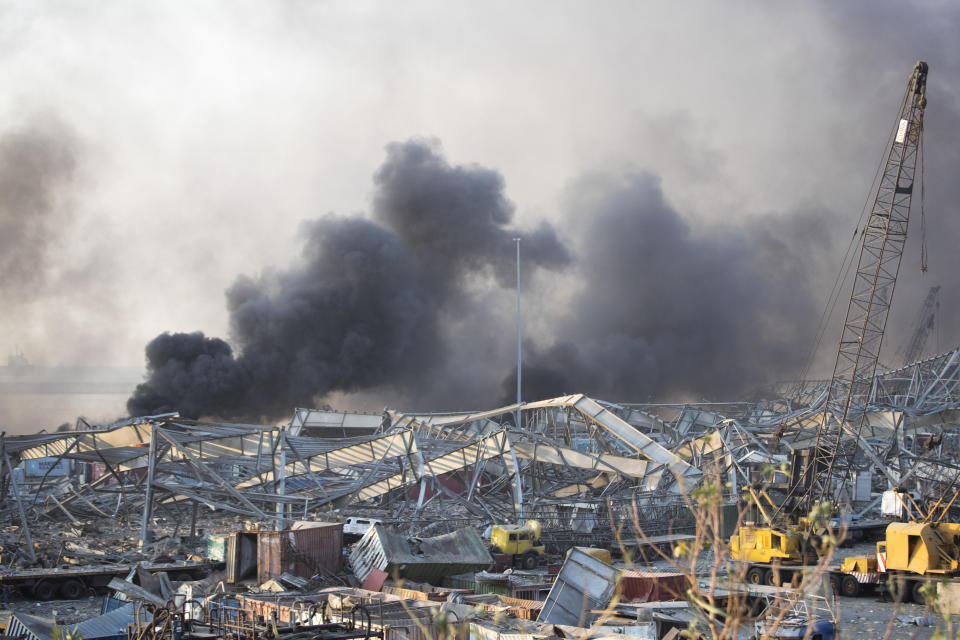 FILE - In this Aug. 4, 2020 file photo, smoke rises in the aftermath of a massive explosion in Beirut, Lebanon. The explosion took 193 lives and wounded 6,500. Among the dead are at least 43 Syrians, plunging a war-weary community into further misery. (AP Photo/Hassan Ammar, File)