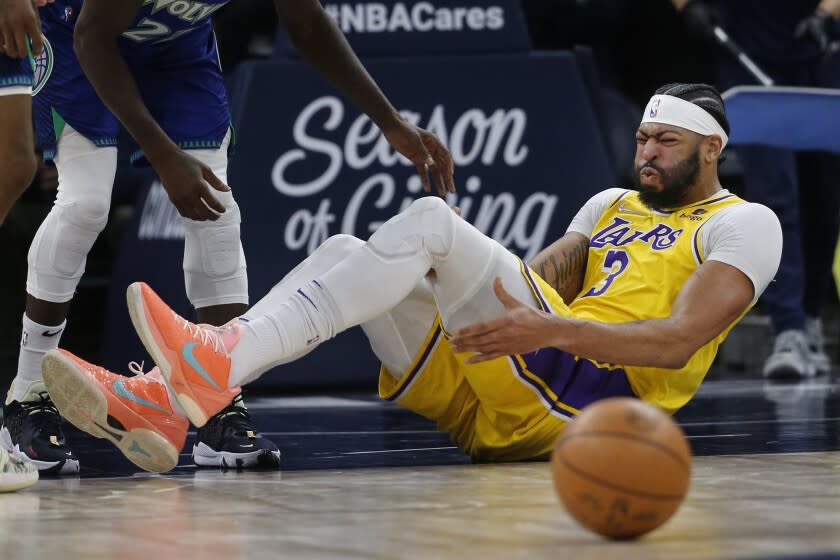 Lakers forward Anthony Davis reacts after falling in the third quarter Dec. 17, 2021, in Minneapolis.