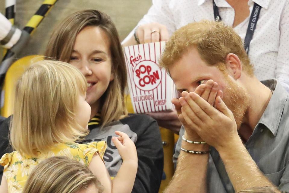 He quickly eats the rest of the popcorn as she watches on.