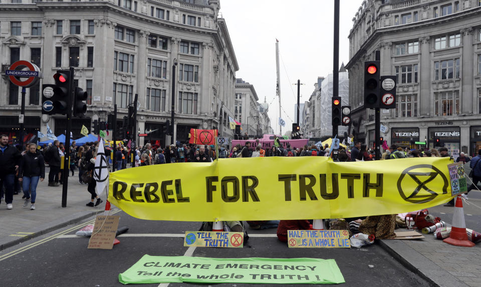 The road is blocked during a climate protest at Oxford Circus in London, Tuesday, April 16, 2019. The group Extinction Rebellion is organizing a week of civil disobedience against what it says is the failure to tackle the causes of climate change. (AP Photo/Kirsty Wigglesworth)