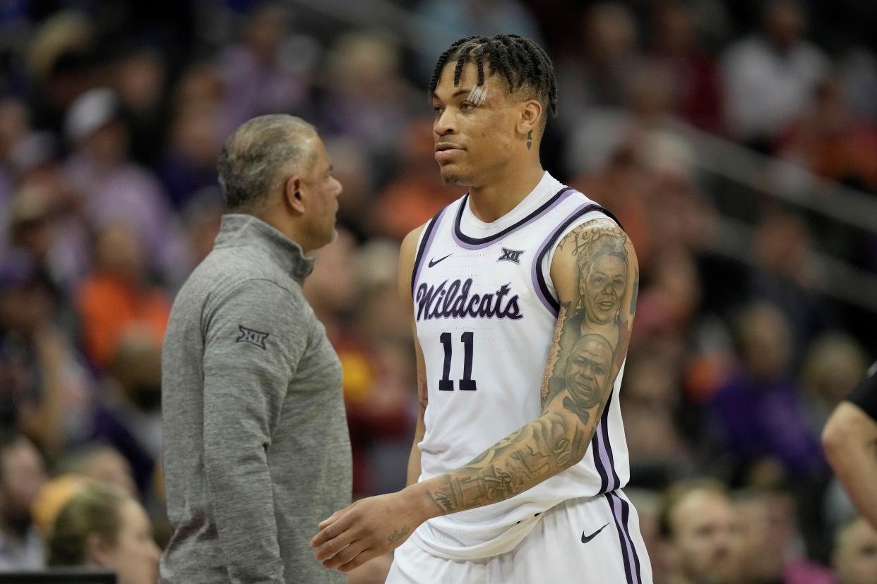 Kansas State forward Keyontae Johnson (11) walks to the bench past coach Jerome Tang after fouling out in the second half of the Wildcats' 80-67 loss to TCU on Thursday in the Big 12 Tournament quarterfinals at T-Mobile Center.