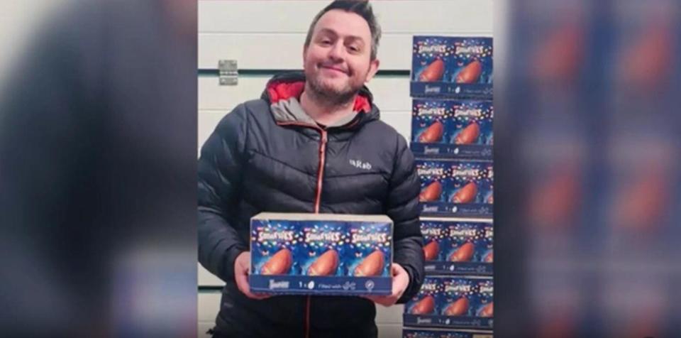 Dan ap Dafydd, owner of the Sinclair General Stores on Scotland's remote Orkney Islands, poses for a photo with a few of the many, many chocolate Easter eggs he mistakenly ordered. / Credit: Courtesy of Dan ap Dafydd