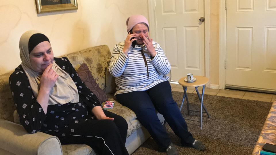 Rouzana Muhajer, left, and Sahab Dabett, right, talk to loved ones hours in Haledon before a scheduled flight to New Zealand. They are going to offers support to a friend whose husband and son were killed in the mosque shooting.