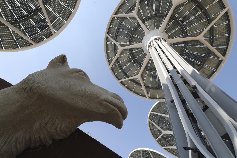 FILE - In this Saturday, Jan. 16, 2021 file photo, energy trees are seen next to a camel sculpture at Terra, The Sustainability Pavilion during a media tour at the Dubai World Expo site in Dubai, United Arab Emirates. Delayed a year over the coronavirus pandemic, Dubai's Expo 2020 opens this Friday. It will put this city-state all-in on its bet of billions of dollars that the world's fair will boost its economy. (AP Photo/Kamran Jebreili, File)