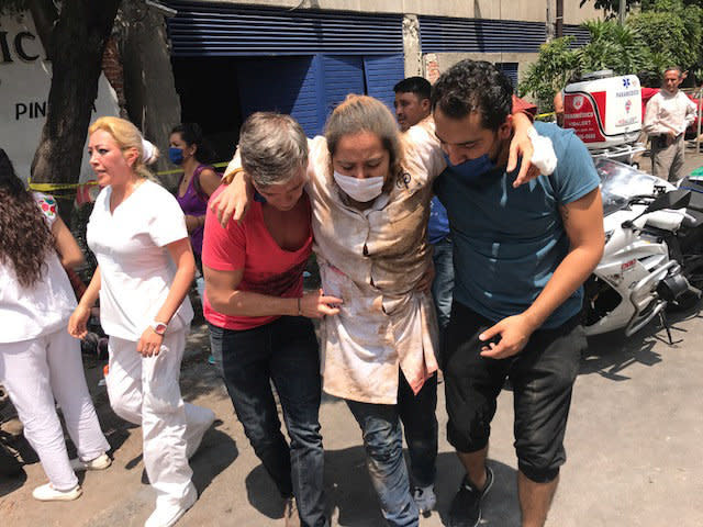 An injured woman is treated after the earthquake.&nbsp;