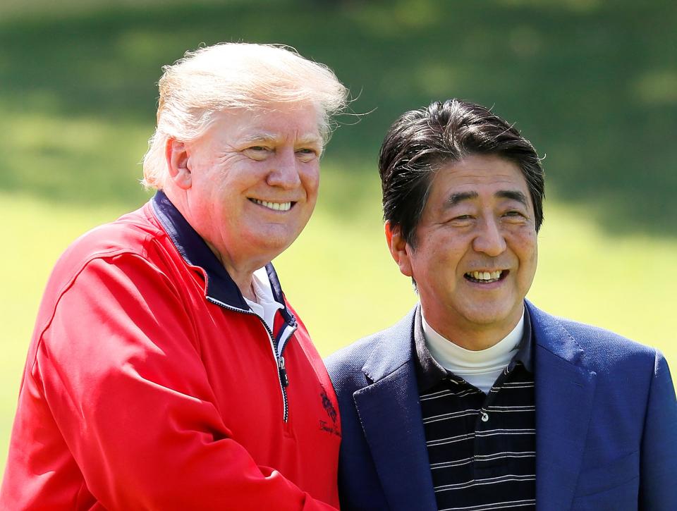 This file photo taken on 26 May 2019 shows Japan’s prime minister Shinzo Abe (R) and US president Donald Trump smiling before playing a round of golf at Mobara Country Club in Chiba (Getty Images)