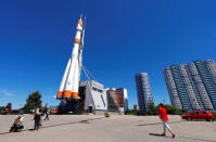 Visitors and locals walk near a Russian rocket that is displayed above the main entrance to the Samara Space Museum in Samara, Russia, June 22, 2018. REUTERS/David Gray