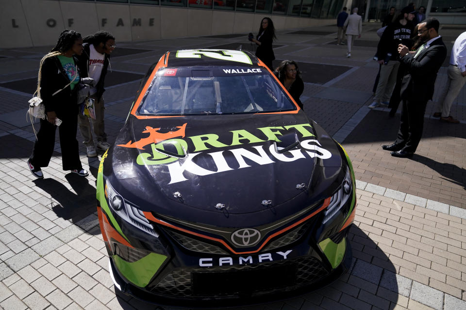 The DraftKings's Bubba Wallace NASCAR car is displayed outside the NASCAR Hall of Fame during an event celebrating the launch of mobile and online sports wagering across North Carolina, Monday, March 11, 2024, in Charlotte, N.C. (AP Photo/Erik Verduzco)