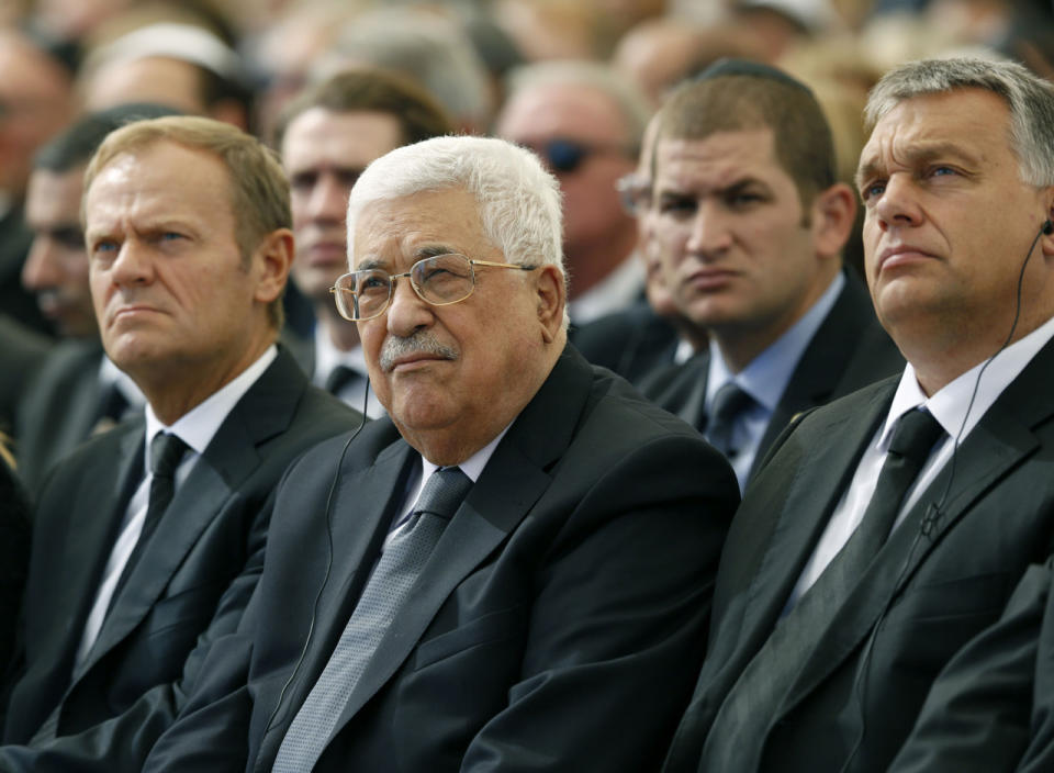 <p>Palestinian President Mahmoud Abbas © sits alongside European Council President Donald Tusk (L) and President of Romania is Klaus Iohannis ® as they attend the funeral of Shimon Peres at Mount Herzl Cemetery on September 30, 2016 in Jerusalem, Israel. (Abir Sultan- Pool/Getty Images)</p>