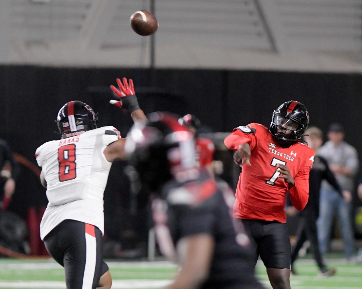 Texas Tech quarterback Cameran Brown (7) delivers a pass over defensive tackle Dooda Banks (8) during the Red Raiders' spring game Saturday at the Sports Performance Center. Brown threw two touchdown passes in the game.
