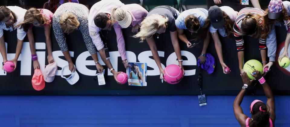 Serena Williams of the U.S. signs autographs after defeating compatriot Madison Keys in their women's singles semi-final match at the Australian Open 2015 tennis tournament in Melbourne January 29, 2015. REUTERS/Brandon Malone (AUSTRALIA - Tags: SPORT TENNIS TPX IMAGES OF THE DAY)
