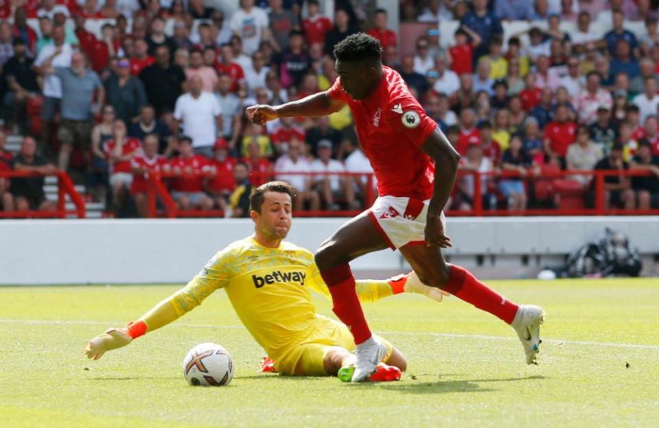 Taiwo Awoniyi takes on Lukasz Fabianski.