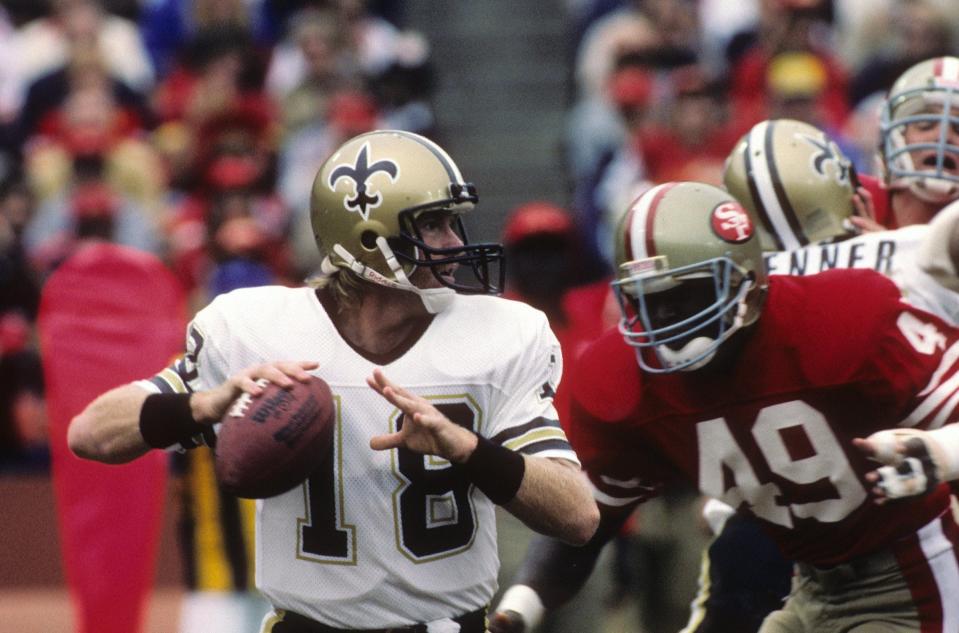 SAN FRANCISCO - SEPTEMBER 29: Quarterback Dave Wilson #18 of the New Orleans Saints looks to throw as defensive back Jeff Fuller #49 of the San Francisco 49ers closes in for a hit during the game at Candlestick Park on September 29, 1985 in San Francisco, California. The Saints won 20-17. (Photo by George Rose/Getty Images)