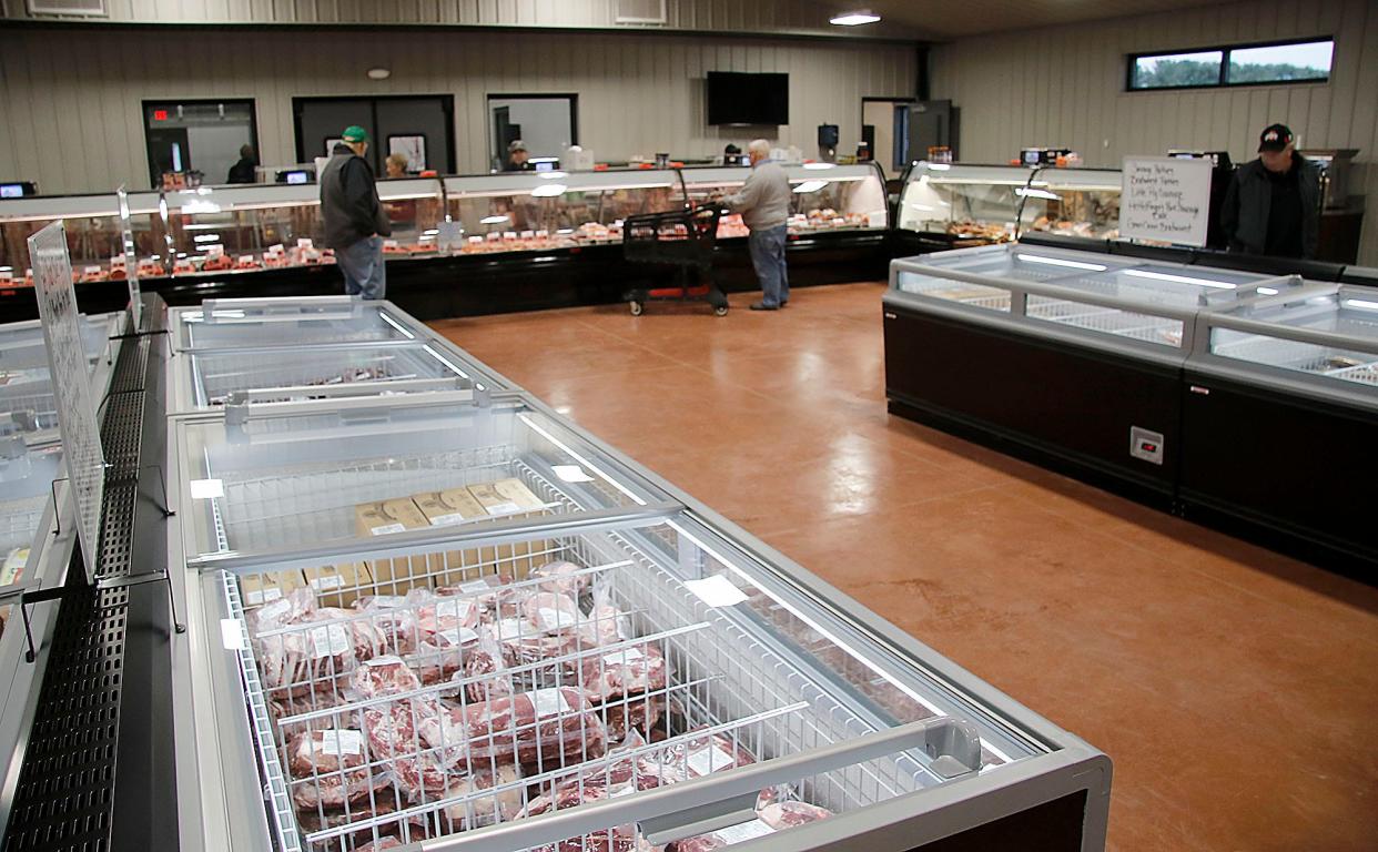 Customers check out the selection at Heffelfinger's Meat Market in Ashland on Friday, Dec. 3, 2021. TOM E. PUSKAR/TIMES-GAZETTE.COM