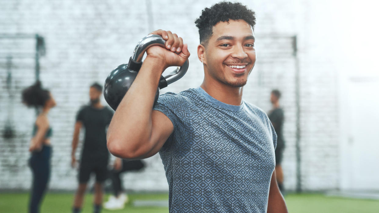  A man holding a kettlebell. 