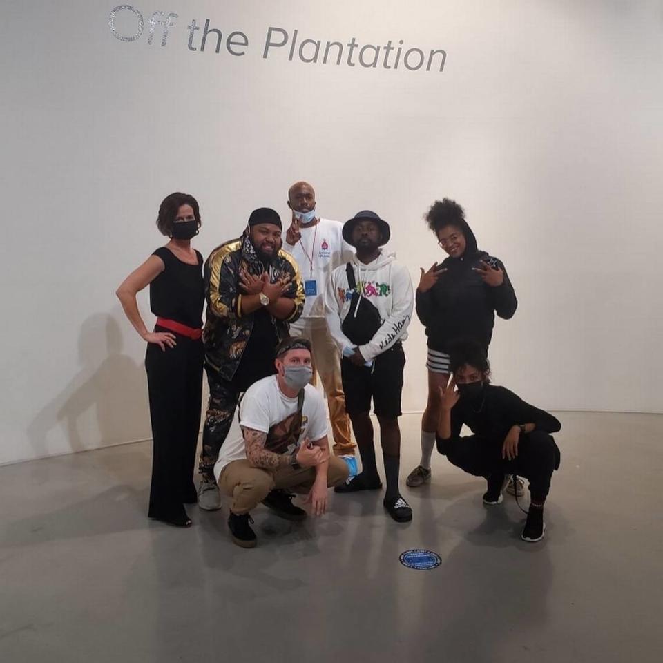 These are the artists and the gallery owner behind the “Off the Plantation” exhibits at Elder Gallery of Contemporary Art. Standing (L to R) are gallery owner Sonya Pfeiffer and artists Will Jenkins, Benjamin Moore, Dammit Wesley and Carla Aaron-Lopez. Kneeling are artists Kyle Mosher and Kiana Mui.