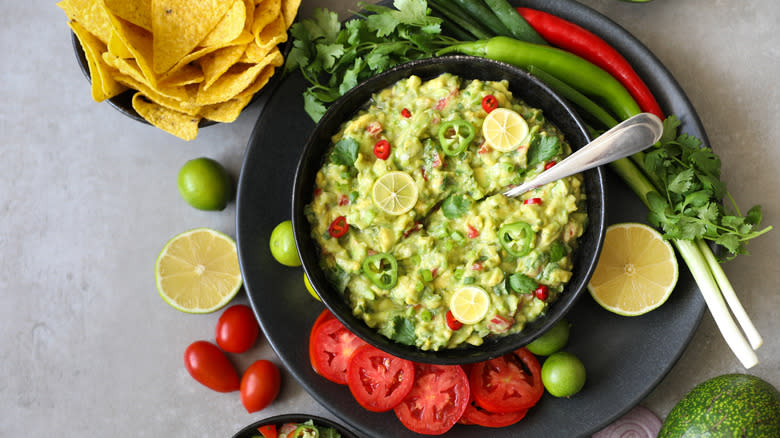 Bowl of guacamole with colorful garnishes