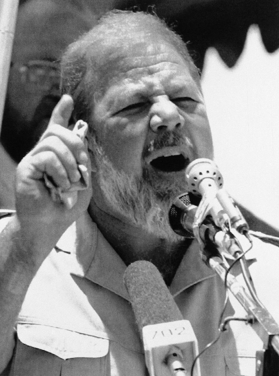 FILE — In this April 6, 1991 file photo taken by South African photographer John Parkin, Eugene Terreblanche, leader of the Afrikaner Resistance Movement gestures while addressing a far right wing political rally in Pretoria, South Africa. Parkin, who covered the country's anti-apartheid struggle, its first democratic elections, and the presidency of Nelson Mandela, has died Monday Aug. 23, 2021, at the age of 63 according to his daughter. (AP Photo/John Parkin/File)