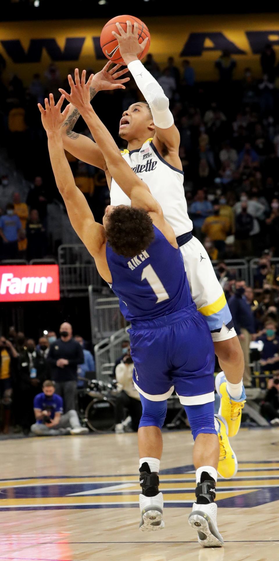 Marquette guard Greg Elliott is fouled by Seton Hall guard Bryce Aiken with 1.7 seconds in the game. Elliott made one of two free throws to put the Golden Eagles ahead, 73-72.