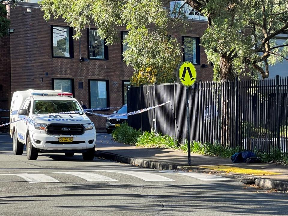 A police vehicle is seen at the scene after a 14-year-old boy was arrested and a 22-year-old man was taken to hospital following a stabbing incident at the University of Sydney in Camperdown, Australia, 2 July 2024 (REUTERS)