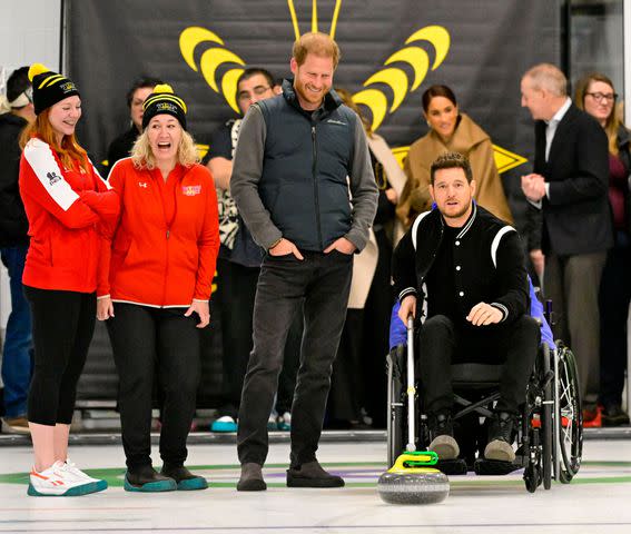 <p>Shutterstock </p> Prince Harry and Michael Buble curling in Canada on Feb. 16, 2024