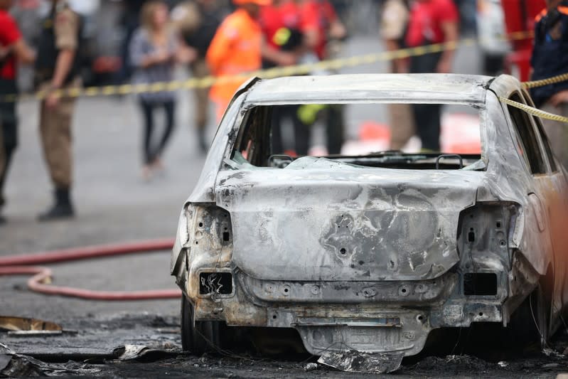 A wrecked car is seen at the site where a small plane crashed on a residential street in Belo Horizonte