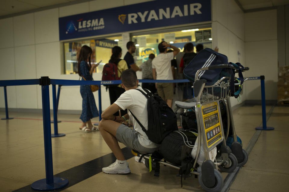 People queue at the Ryanair airline customer service desk during the first of two days cabin crew strike at Adolfo Suarez-Barajas international airport in Madrid, Wednesday, July 25, 2018. Budget airline Ryanair cabin crew are to stage a 48-hour strike July 25 and 26 in Spain, Portugal, Italy and Belgium. (AP Photo/Francisco Seco)