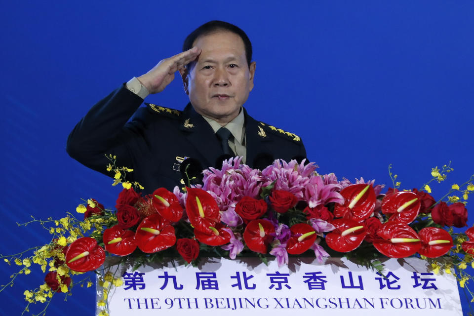 Chinese Defense Minister Wei Fenghe salutes after delivering his opening speech for the Xiangshan Forum, a gathering of the region's security officials, in Beijing, Monday, Oct. 21, 2019. Wei issued a stinging rebuke of the U.S. at a defense forum in Beijing, saying China wasn't fazed by sanctions, pressure and a "big stick policy." (AP Photo/Andy Wong)