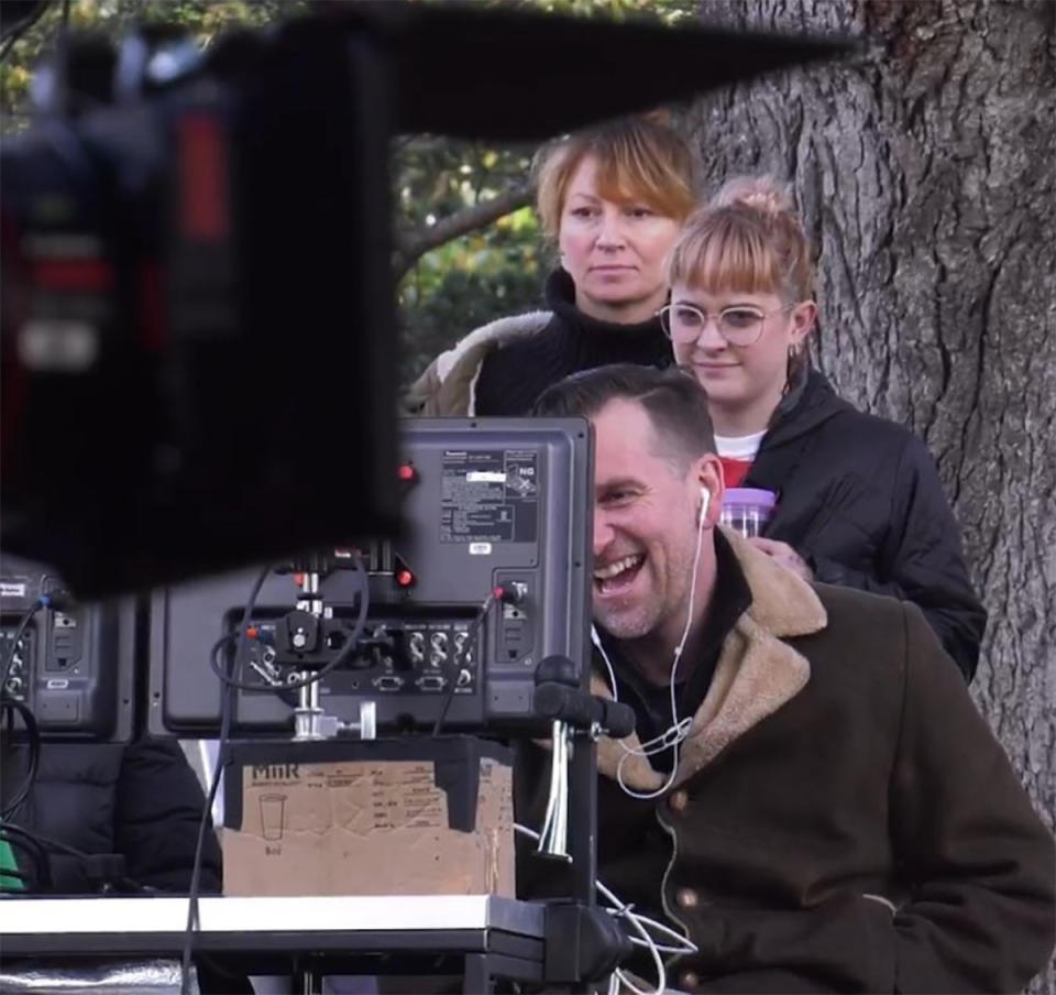 Former Heartbreak High star Scott Major laughs behind camera equipment on set. Photo: Instagram/scottmaj.