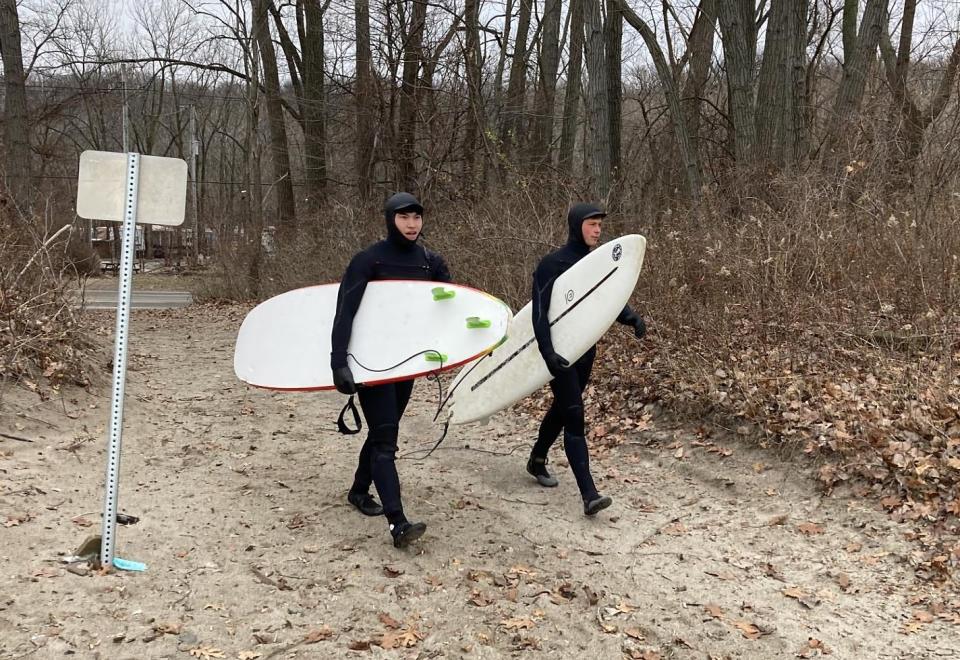 Ty Corbin, left, a 19-year-old Fairview Township resident, and his friend, Samuel Harmston, 20, of Millcreek Township, arrive on Dec. 7 to surf at Presque Isle State Park's Beach 1 West.