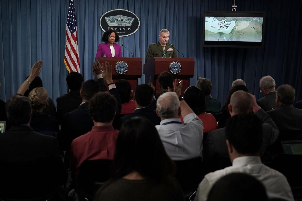 Pentagon Chief Spokesperson Dana W. White (L) and Marine Lt. Gen. Kenneth F. McKenzie Jr. (R), participate in a news briefing at the Pentagon April 14, 2018 in Arlington, Virginia.