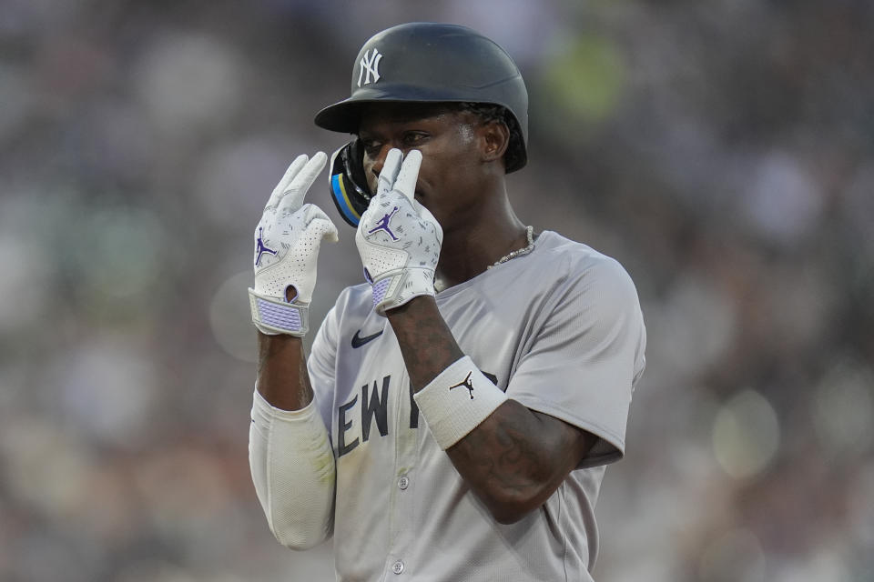 New York Yankees' Jazz Chisholm Jr. signals to the dugout after hitting a single during the second inning of a baseball game against the Chicago White Sox, Monday, Aug. 12, 2024, in Chicago. (AP Photo/Erin Hooley)