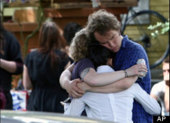 Friends, family and employees react after a shooting at Cafe Racer in Seattle on May 30, 2012. A lone gunman killed four people Wednesday -- three were shot to death at a cafe, and a fourth in a carjacking. The gunman later killed himself.