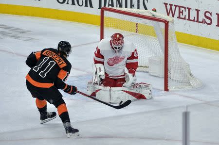 Feb 16, 2019; Philadelphia, PA, USA; Detroit Red Wings goaltender Jonathan Bernier (45) makes the initial save on Philadelphia Flyers right wing Travis Konecny (11) during the overtime period of the game at the Wells Fargo Center. The Philadelphia Flyers won 6-5 in overtime. Mandatory Credit: John Geliebter-USA TODAY Sports