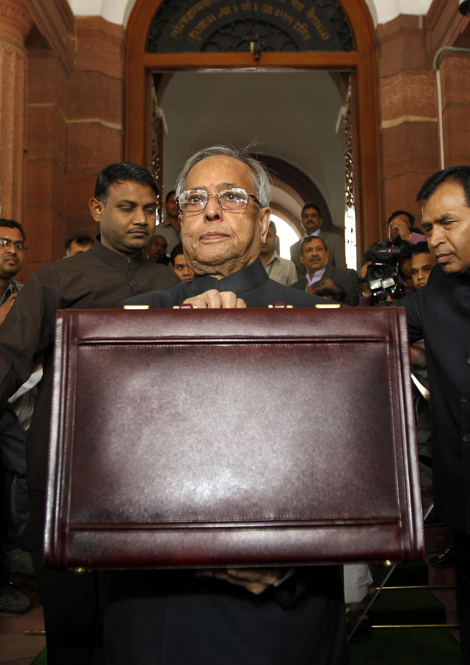 Indian Finance Minister Pranab Mukherjee holds a briefcase containing the annual budget documents as he arrives at the Indian Parliament in New Delhi, India, Friday, March 16, 2012. Mukherjee presented India's new budget Friday amid concerns about inflation, the country's falling growth rate and its large deficit. (AP Photo/Saurabh Das)