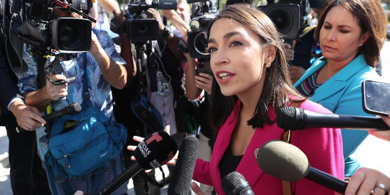 Rep. Alexandria Ocasio-Cortez talks to reporters outside the US Capitol building.