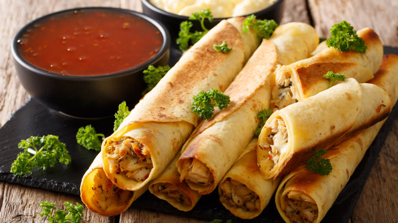 Platter of taquitos with salsa