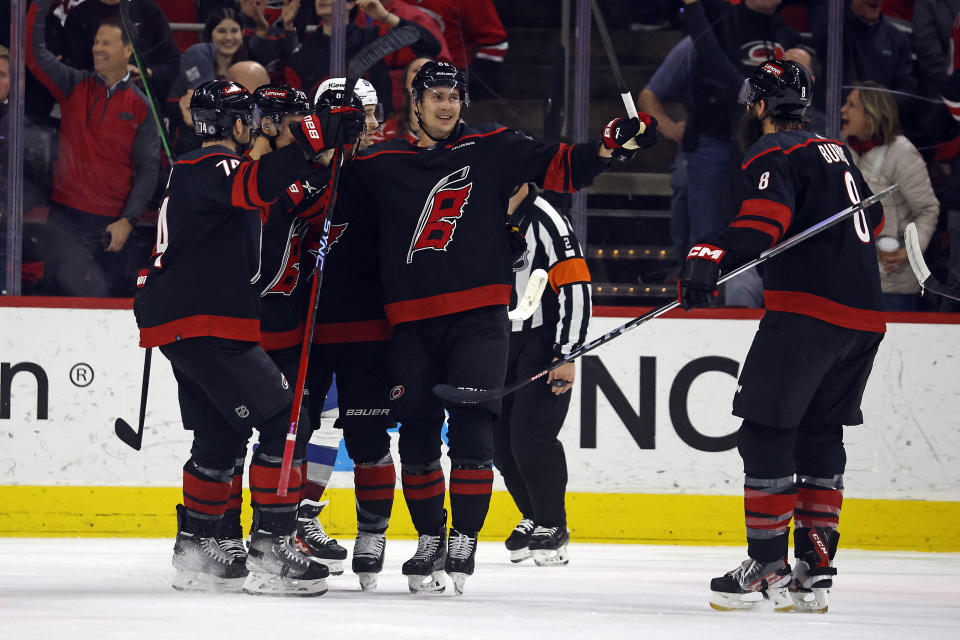 Carolina Hurricanes' Martin Necas, right, celebrates with teammates after his goal against the Colorado Avalanche during the first period of an NHL hockey game in Raleigh, N.C., Thursday, Feb. 8, 2024. (AP Photo/Karl B DeBlaker)